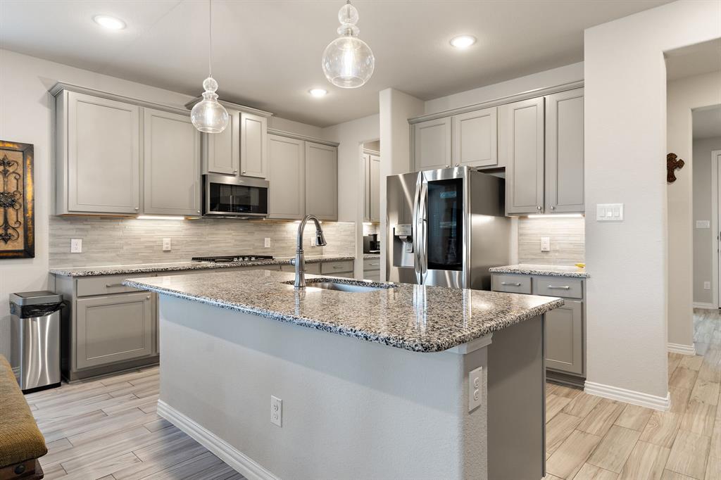 2012 Elara Drive Haslet, TX 76052 - Photo 6 of 34 a kitchen with stainless steel appliances granite countertop a refrigerator a sink and a stove