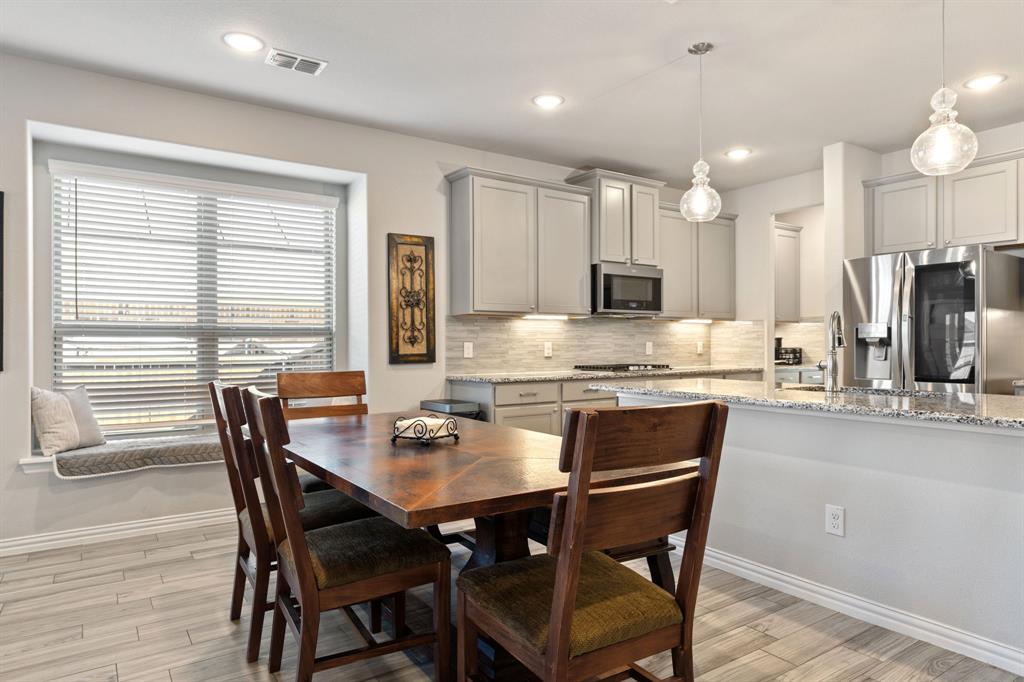 2012 Elara Drive Haslet, TX 76052 - Photo 8 of 34 a kitchen with kitchen island a dining table and chairs