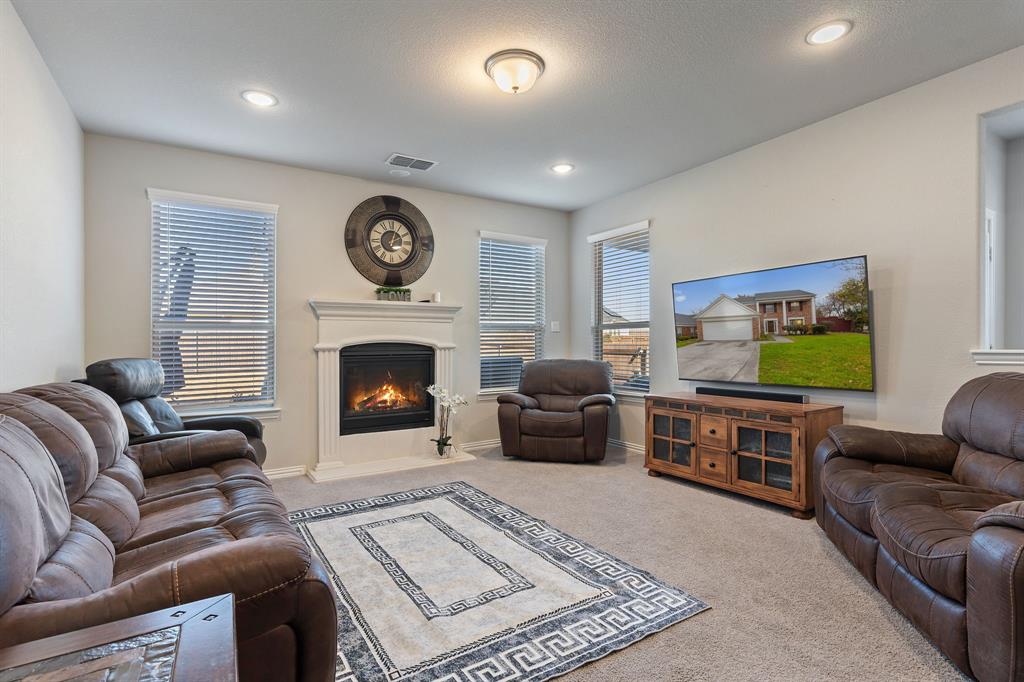 2012 Elara Drive Haslet, TX 76052 - Photo 9 of 34 a living room with furniture and a fireplace