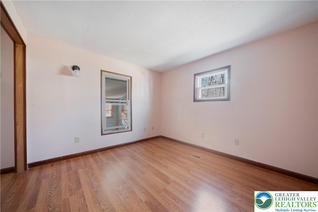 664 Cranberry Road, Unit 1 East Stroudsburg, PA 18301 - Photo 11 of 22 a view of an empty room with wooden floor and a window
