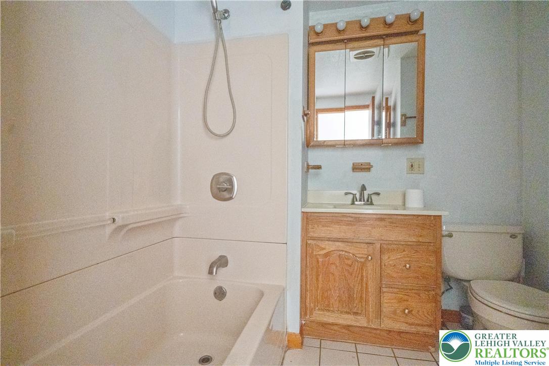 664 Cranberry Road, Unit 1 East Stroudsburg, PA 18301 - Photo 14 of 22 a bathroom with a granite countertop sink a toilet and shower