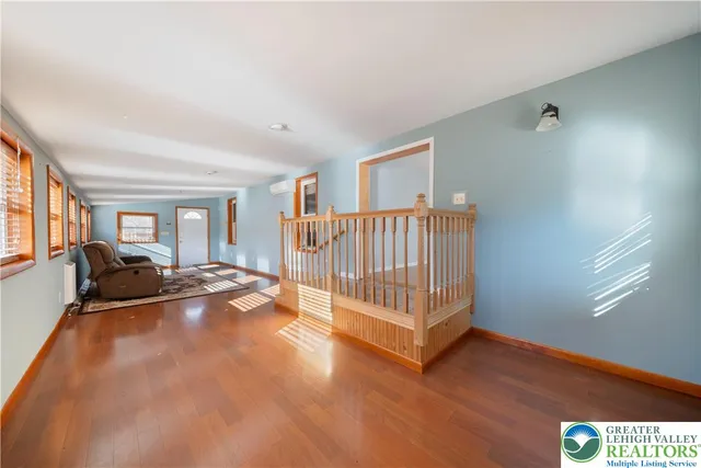 a view of a livingroom with furniture and staircase