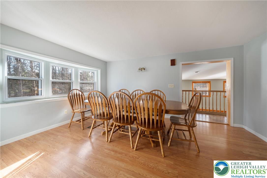 664 Cranberry Road, Unit 1 East Stroudsburg, PA 18301 - Photo 4 of 22 a view of a dining room with furniture window and wooden floor