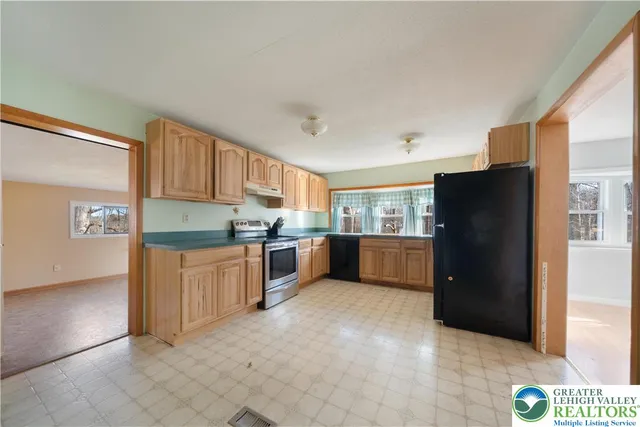 a kitchen with stainless steel appliances a refrigerator and a sink