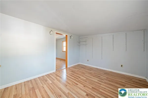 a view of an empty room with wooden floor
