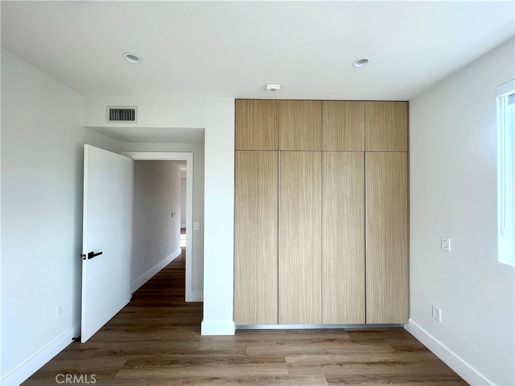 2828 London Street, Unit 304 Los Angeles, CA 90026 - Photo 11 of 23 a view of a hallway with wooden floor