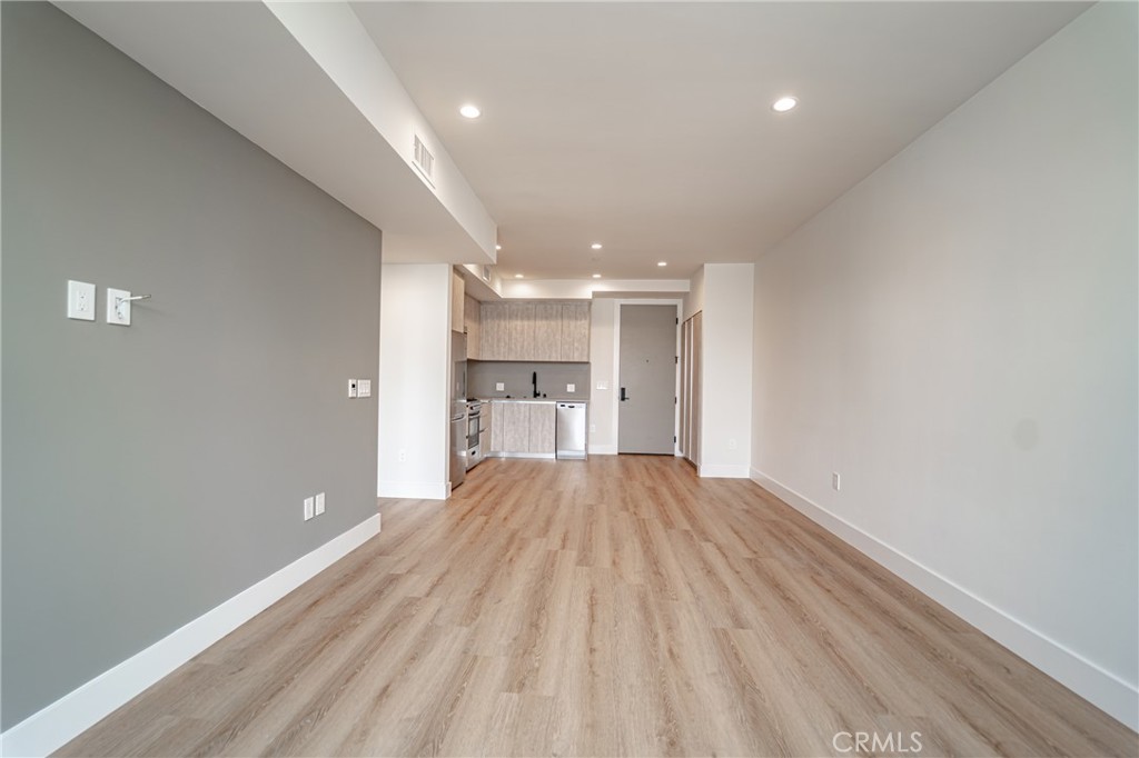 2828 London Street, Unit 304 Los Angeles, CA 90026 - Photo 5 of 23 a view of empty room with wooden floor