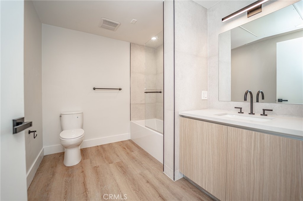 2828 London Street, Unit 304 Los Angeles, CA 90026 - Photo 6 of 23 a bathroom with a sink a toilet and shower