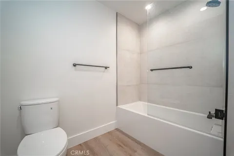 a bathroom with a toilet and a bath tub