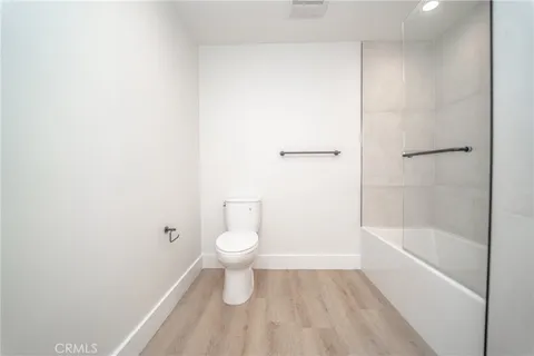 a bathroom with a toilet and a bathtub