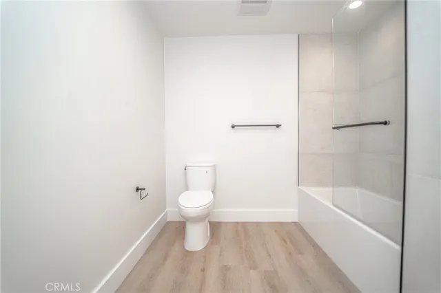 a bathroom with a toilet and a bathtub