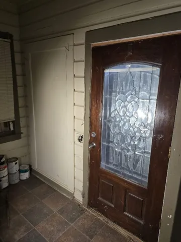 a view of kitchen with refrigerator and window
