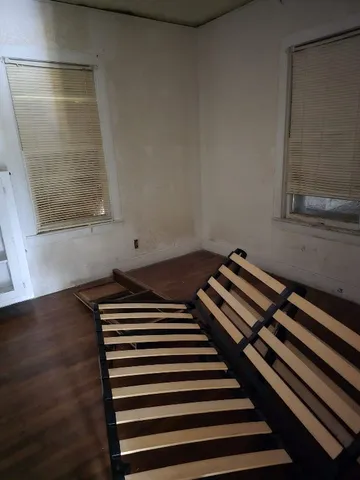 a room with water heater and wooden cabinets