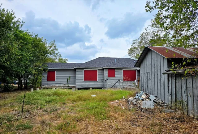 a backyard of a house with table and chairs