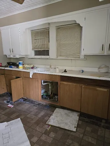 a room with wooden cabinets and a sink