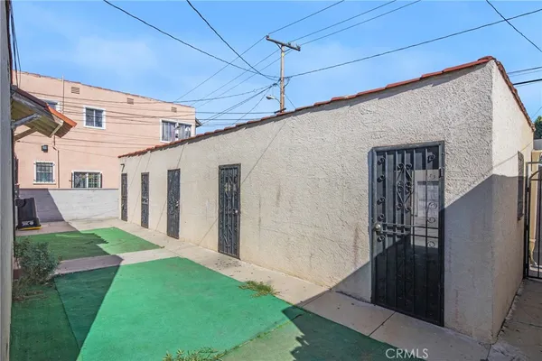 a view of a house with a wooden fence