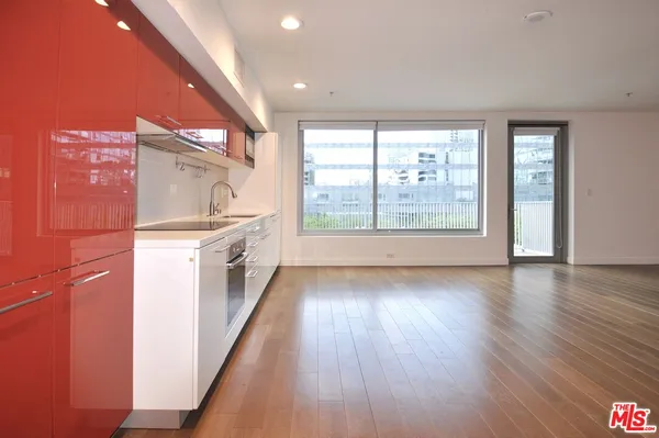 a view of a kitchen with a sink and wooden floor