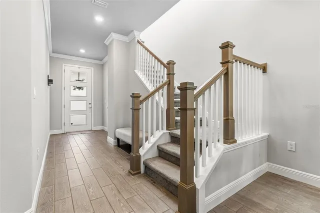 a kitchen with stainless steel appliances kitchen island granite countertop a refrigerator and a sink