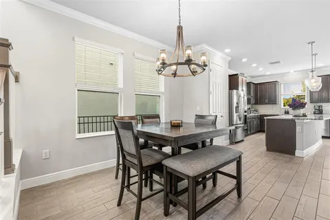 a large kitchen with kitchen island a stove a sink a center island and a wooden floor