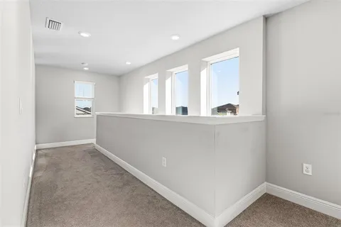 a bathroom with a granite countertop toilet sink and mirror
