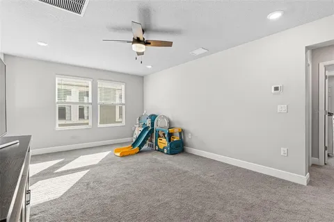 a view of a room with furniture and a window