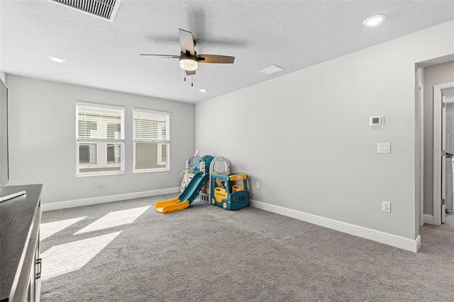 a view of a room with furniture and a window