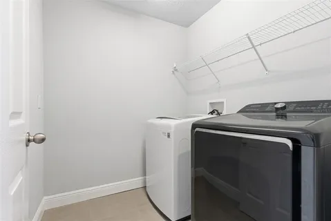an aerial view of a house with a garden and lake view