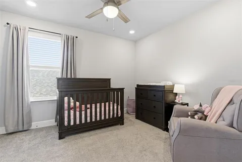 a dining room with stainless steel appliances granite countertop a stove a refrigerator a dining table and chairs with wooden floor