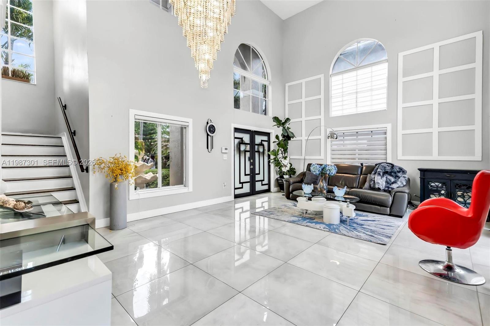 12940 Southwest 142nd Terrace Miami, FL 33186 - Photo 11 of 44 a living room with fireplace furniture and a large window