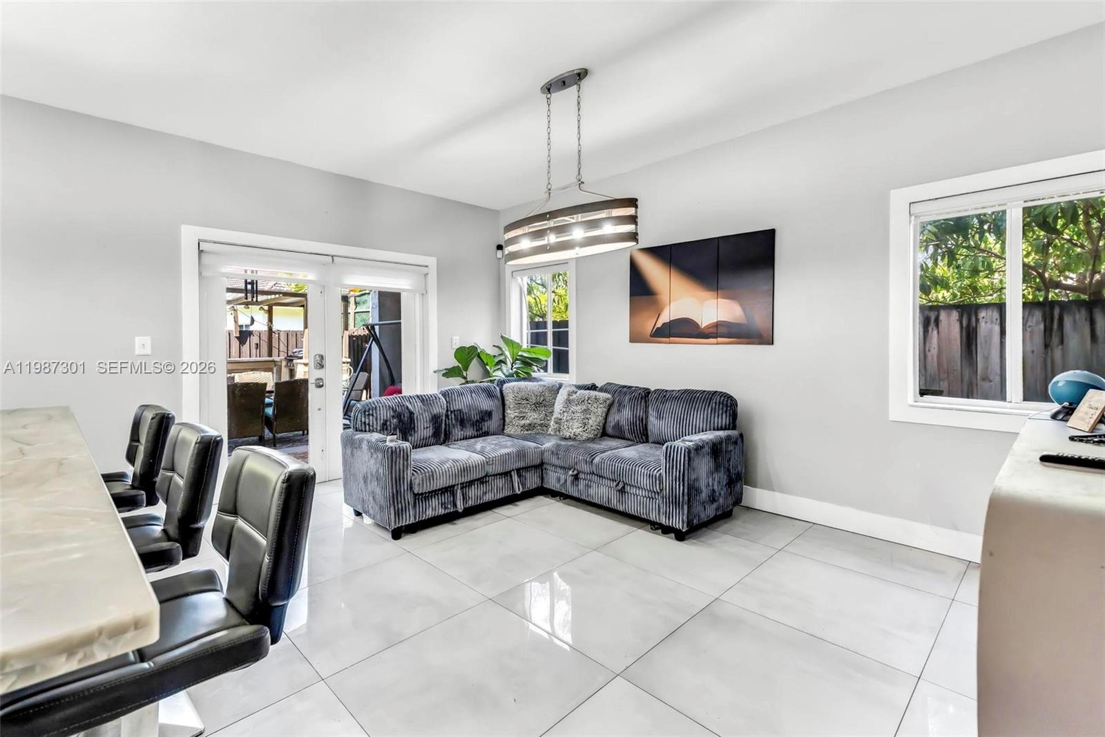 12940 Southwest 142nd Terrace Miami, FL 33186 - Photo 13 of 44 a living room with furniture and a flat screen tv