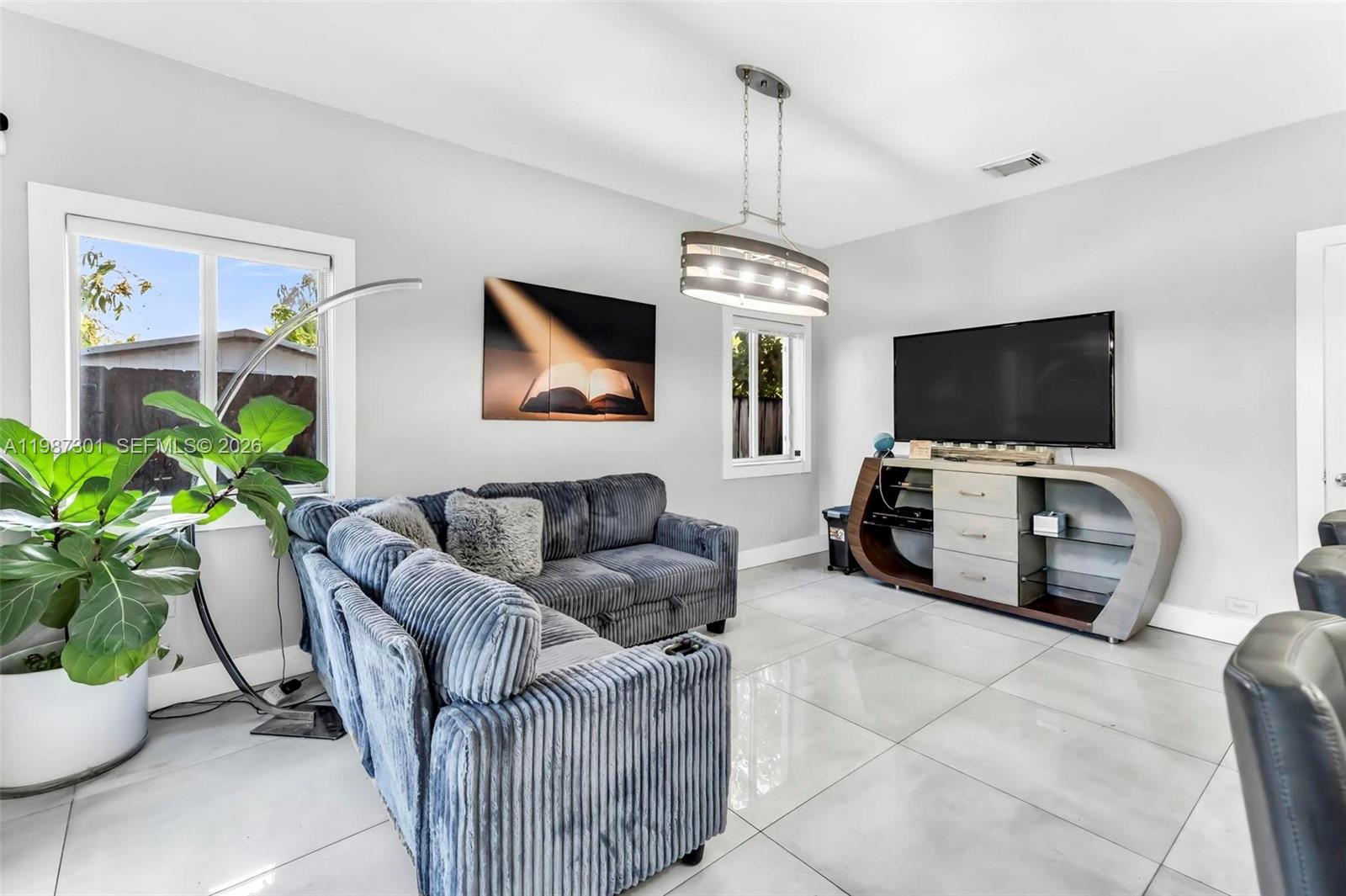 12940 Southwest 142nd Terrace Miami, FL 33186 - Photo 14 of 44 a living room with furniture and a flat screen tv