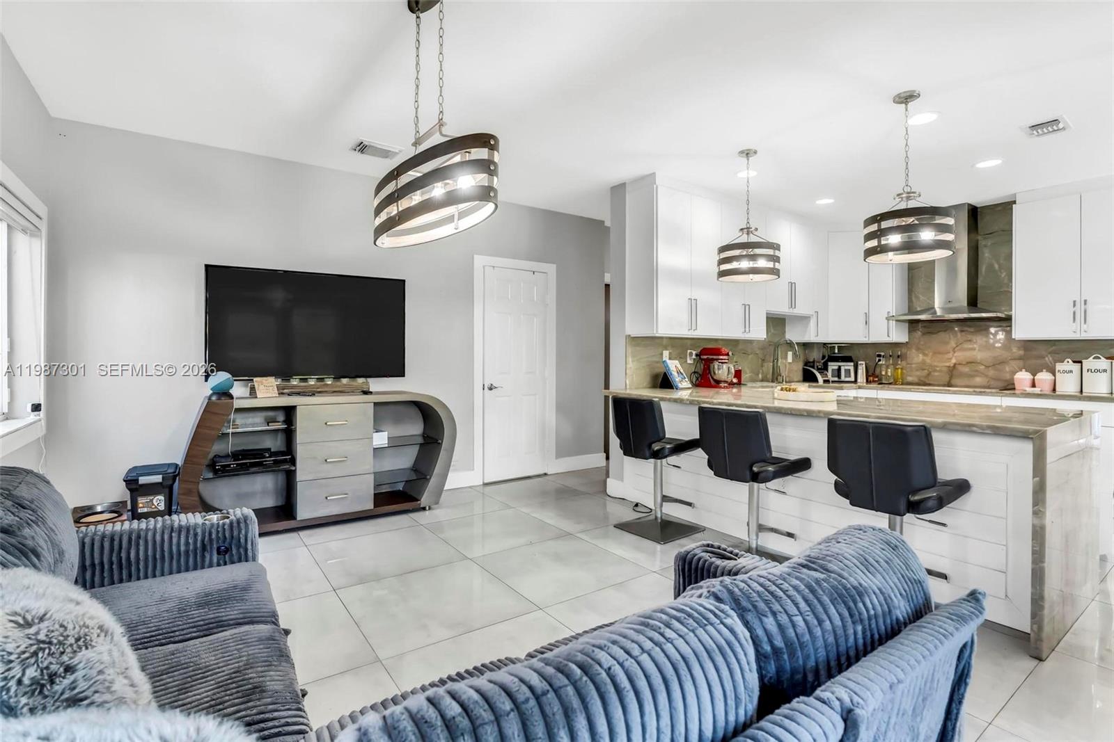 12940 Southwest 142nd Terrace Miami, FL 33186 - Photo 15 of 44 a living room with furniture and a flat screen tv