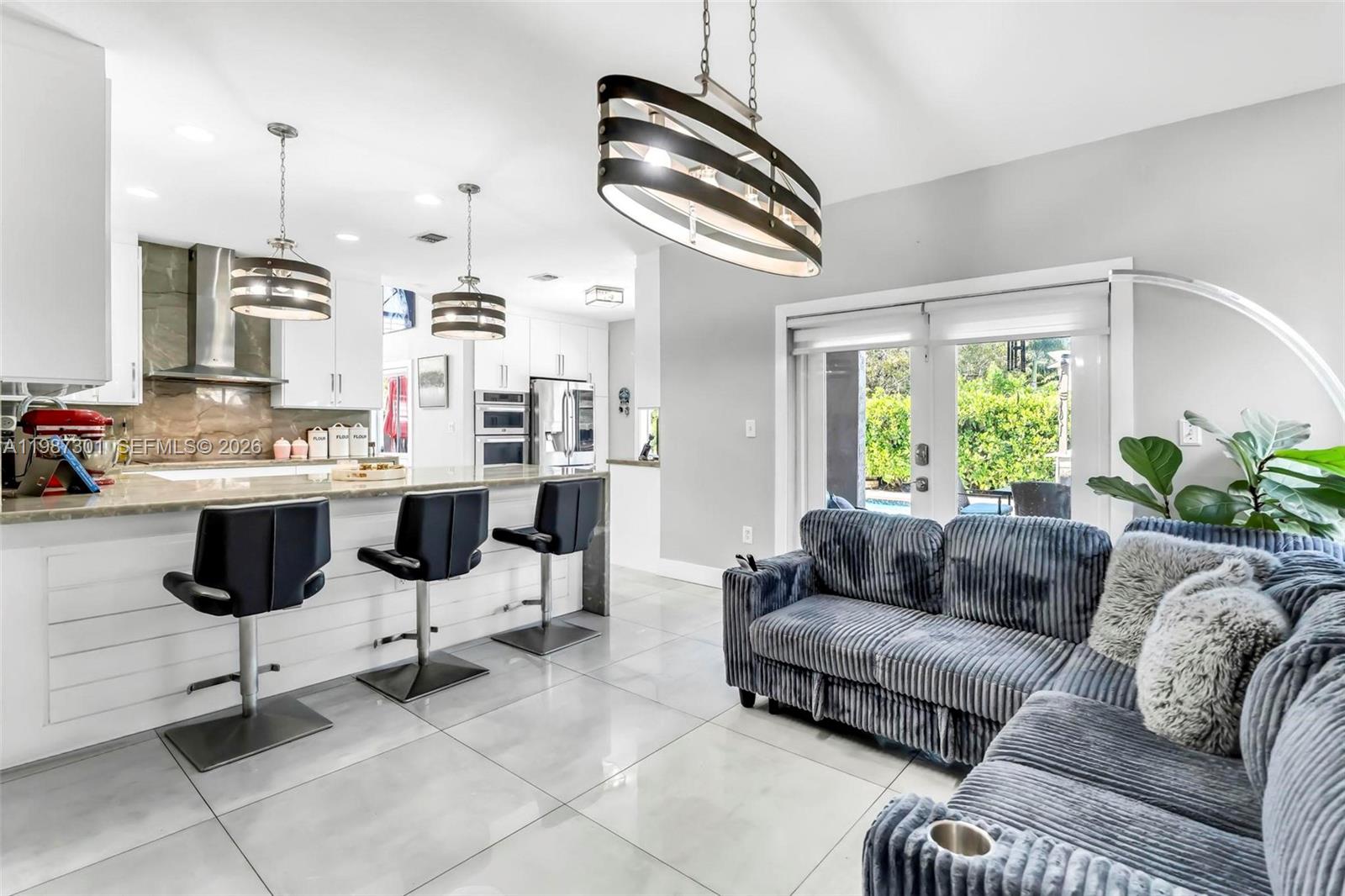 12940 Southwest 142nd Terrace Miami, FL 33186 - Photo 16 of 44 a living room with furniture and a large window