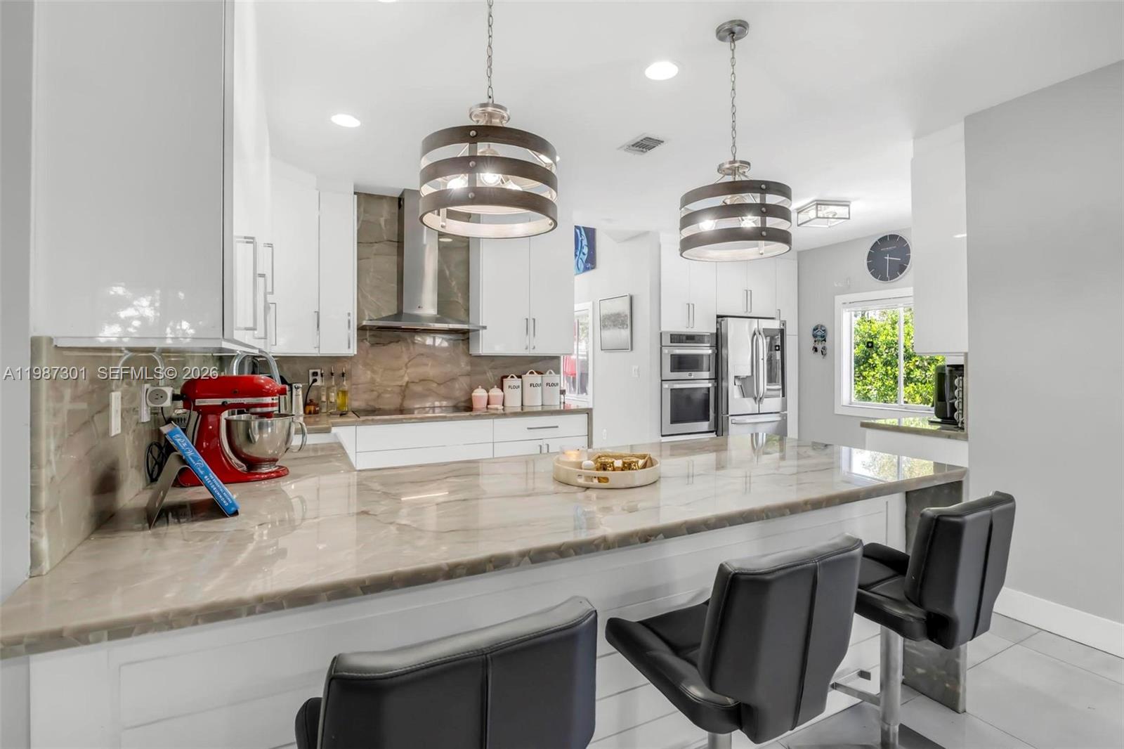 12940 Southwest 142nd Terrace Miami, FL 33186 - Photo 18 of 44 a kitchen with stainless steel appliances granite countertop a sink a stove and a wooden floors