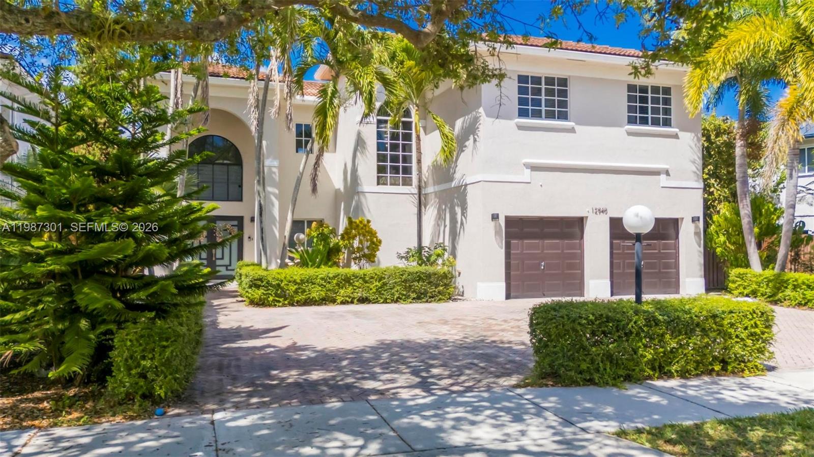 12940 Southwest 142nd Terrace Miami, FL 33186 - Photo 2 of 44 a front view of a house with a yard