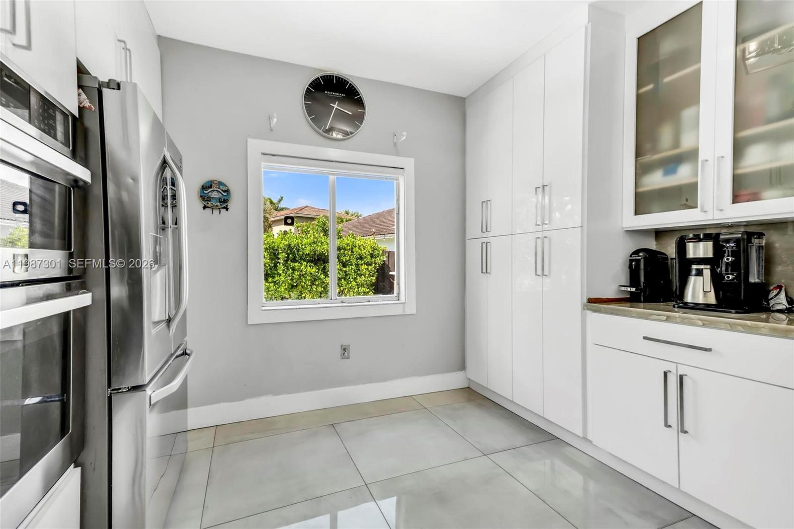 12940 Southwest 142nd Terrace Miami, FL 33186 - Photo 21 of 44 a kitchen with stainless steel appliances a refrigerator and a stove top oven