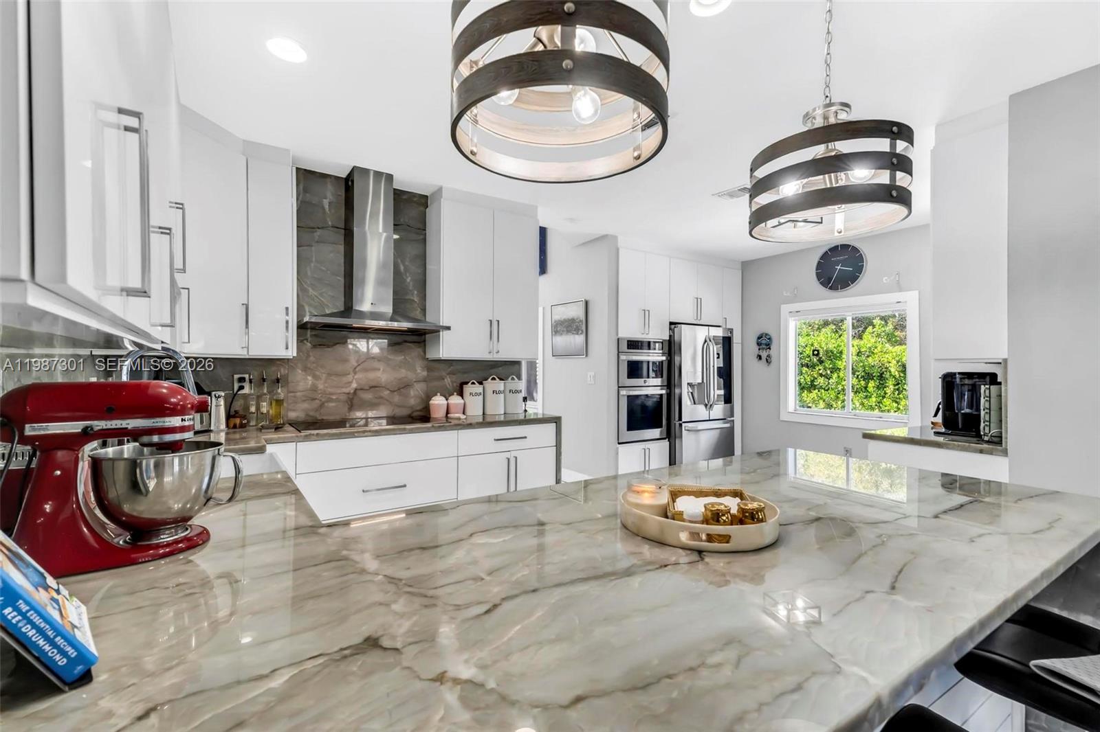 12940 Southwest 142nd Terrace Miami, FL 33186 - Photo 23 of 44 a kitchen with stainless steel appliances granite countertop a stove a sink and a white cabinets