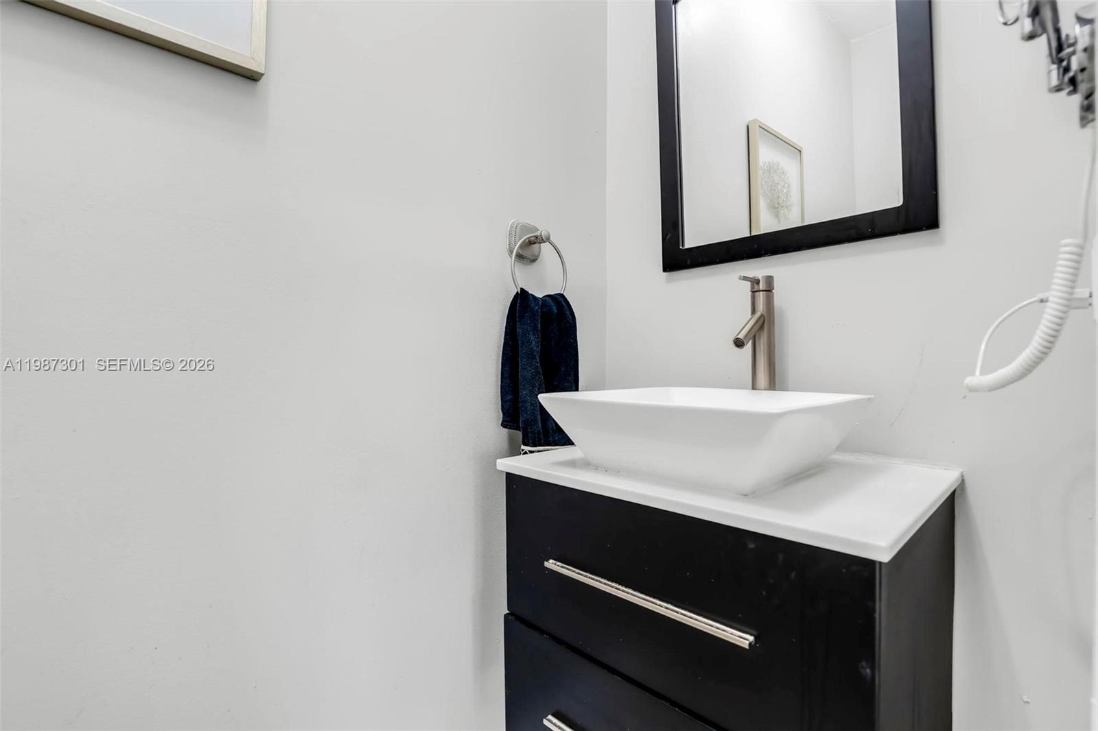 12940 Southwest 142nd Terrace Miami, FL 33186 - Photo 24 of 44 a bathroom with a sink and a mirror