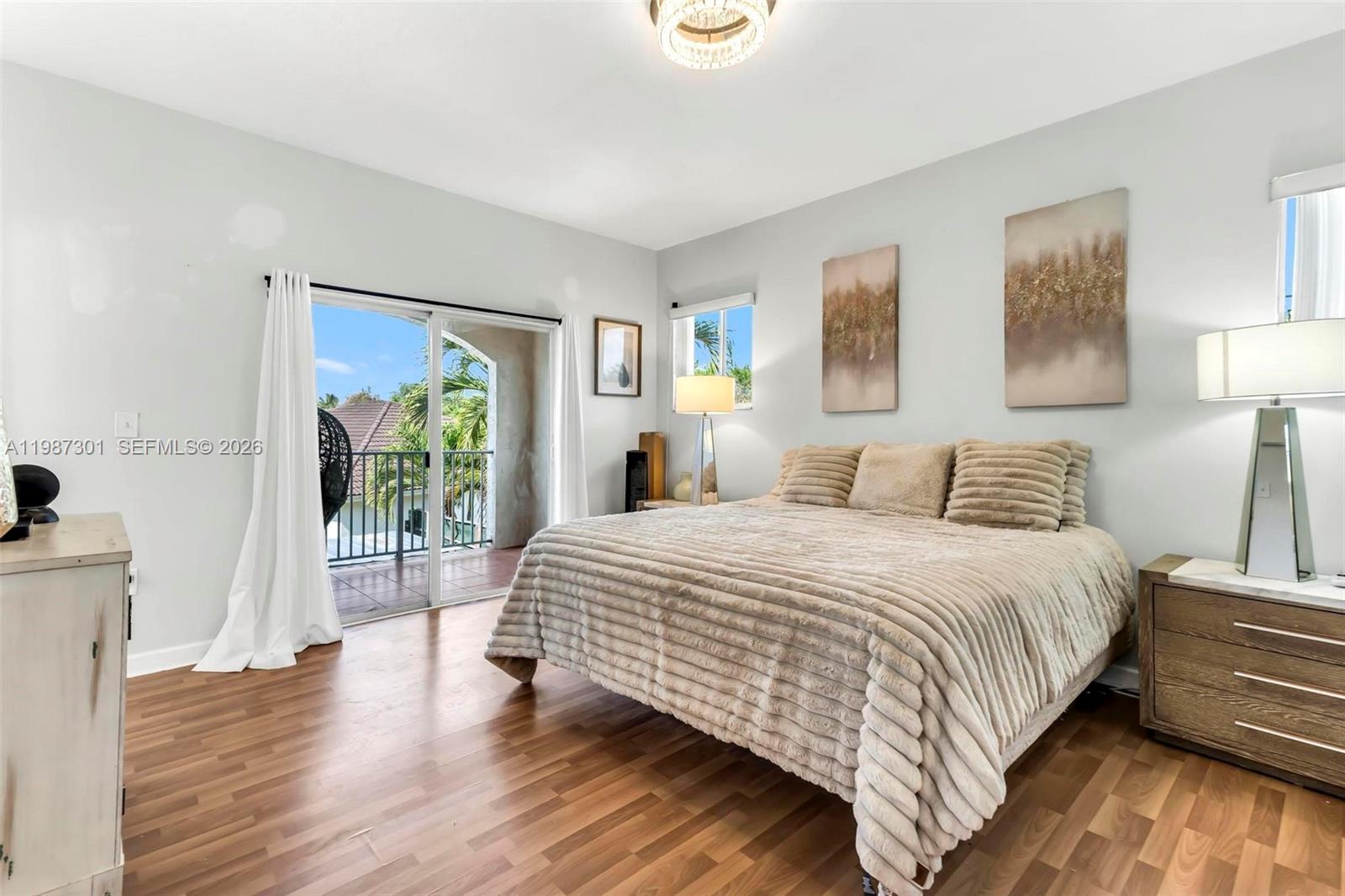 12940 Southwest 142nd Terrace Miami, FL 33186 - Photo 27 of 44 a bedroom with a bed and a wooden floor