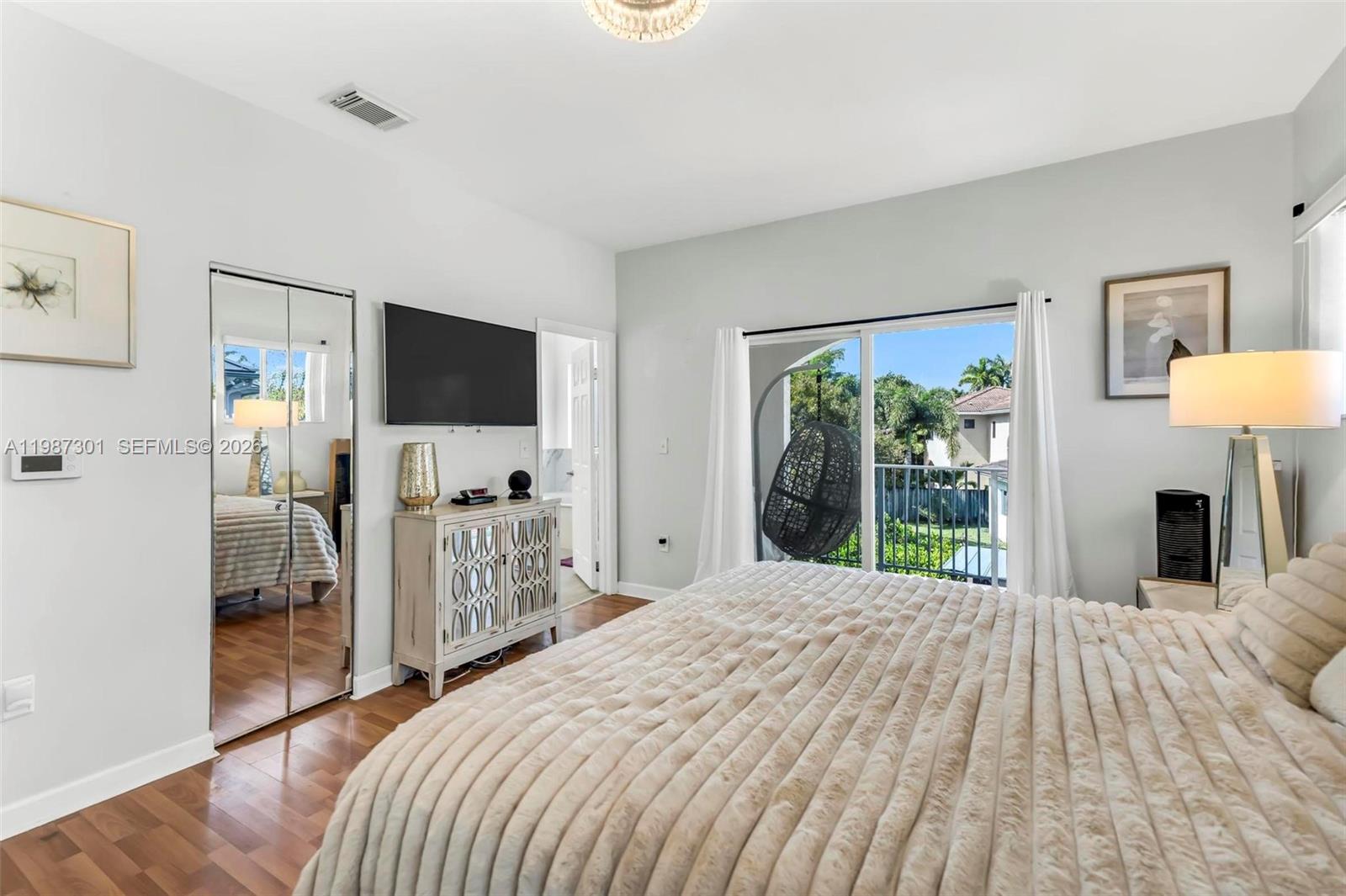 12940 Southwest 142nd Terrace Miami, FL 33186 - Photo 28 of 44 a bedroom with a bed and a flat tv screen in it