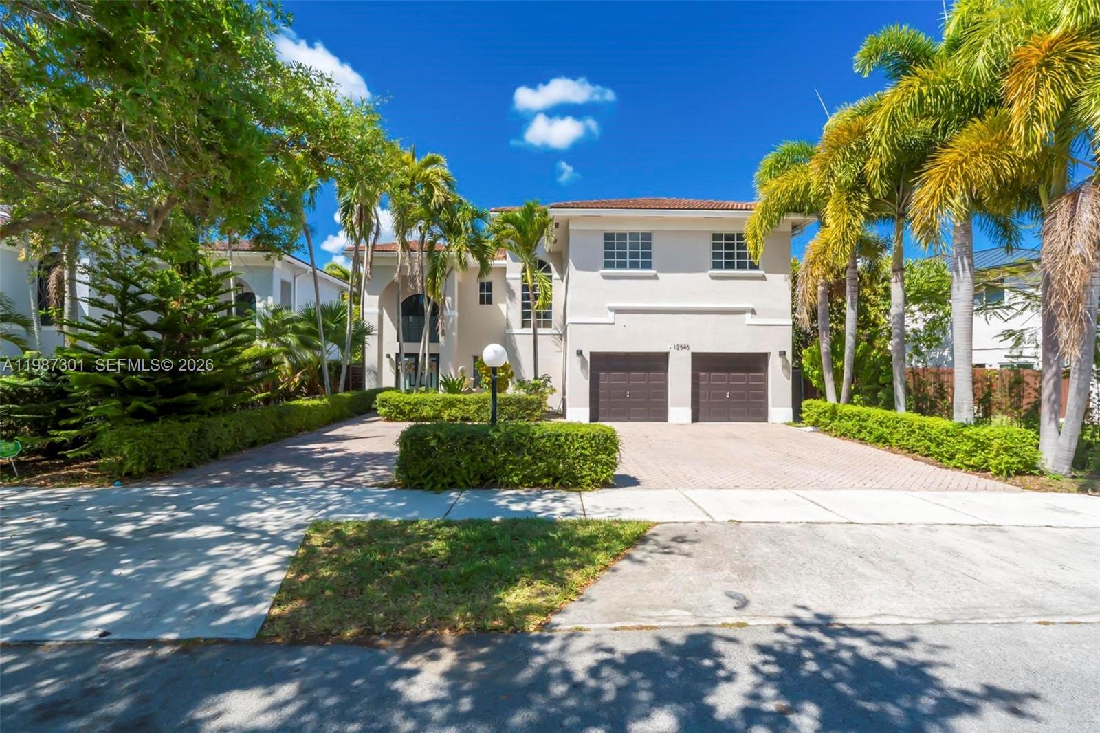 12940 Southwest 142nd Terrace Miami, FL 33186 - Photo 3 of 44 a front view of a house with a yard