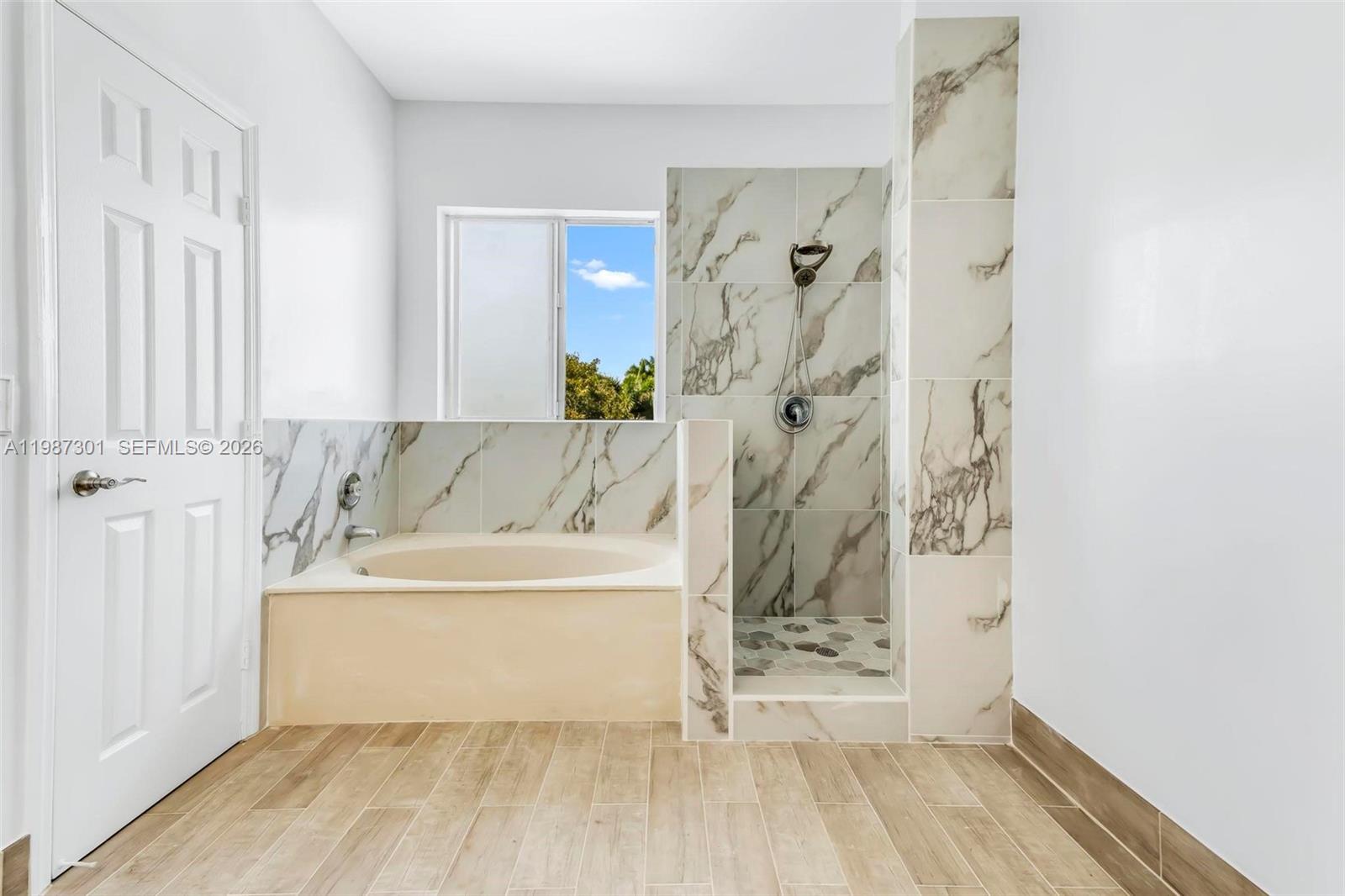 12940 Southwest 142nd Terrace Miami, FL 33186 - Photo 32 of 44 a bathroom with a bathtub and a shower