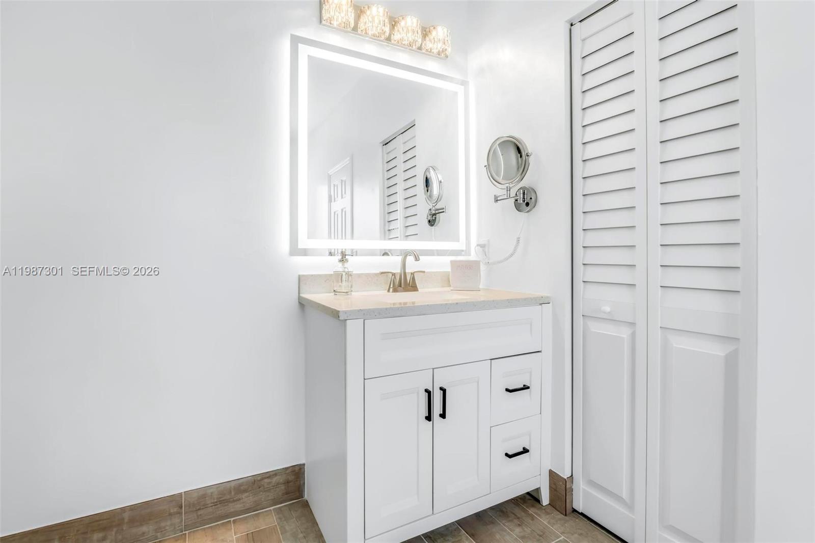 12940 Southwest 142nd Terrace Miami, FL 33186 - Photo 33 of 44 a bathroom with a sink and a mirror