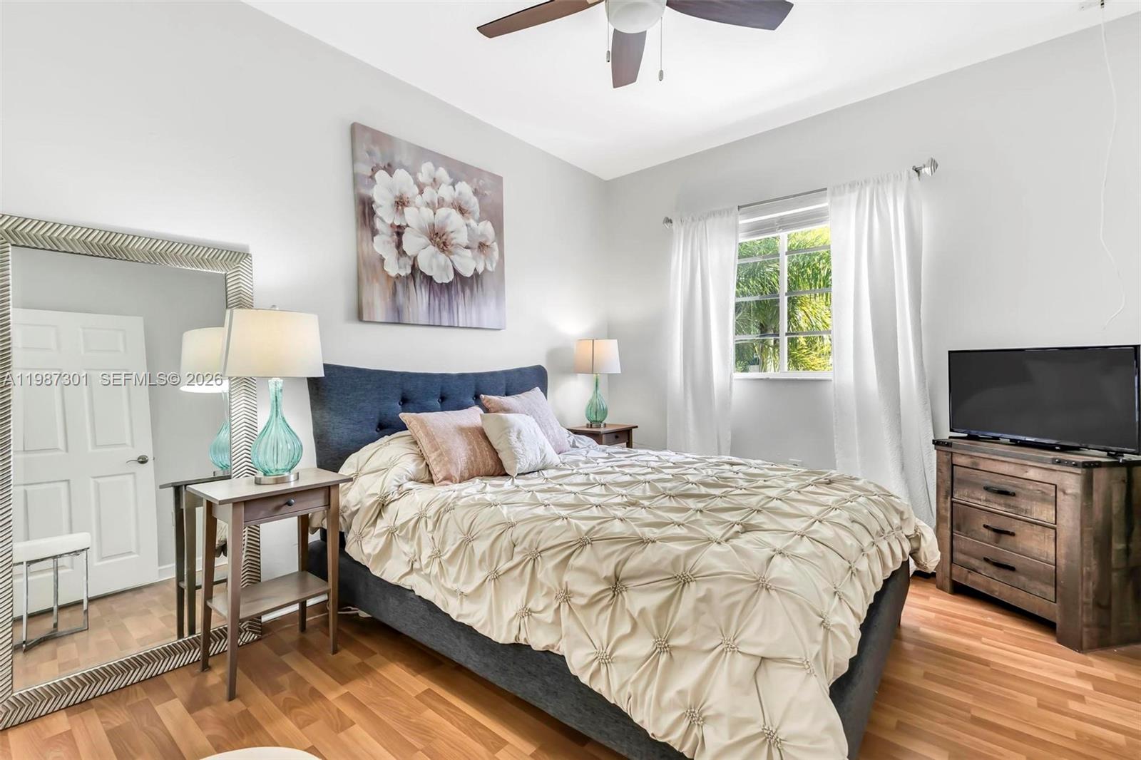 12940 Southwest 142nd Terrace Miami, FL 33186 - Photo 34 of 44 a bedroom with a bed and a flat screen tv