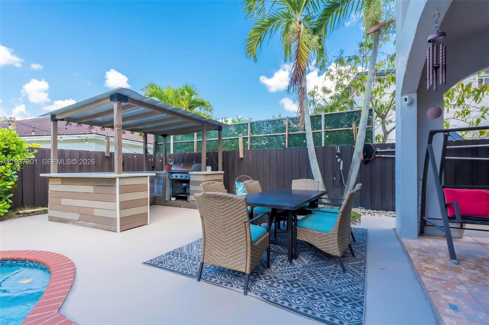 12940 Southwest 142nd Terrace Miami, FL 33186 - Photo 38 of 44 a view of a chairs and table in the patio