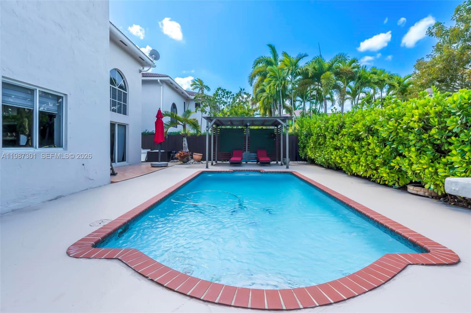 12940 Southwest 142nd Terrace Miami, FL 33186 - Photo 40 of 44 an outdoor space with swimming pool and furniture