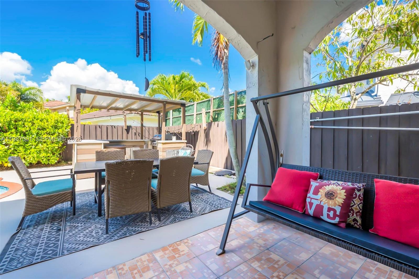 12940 Southwest 142nd Terrace Miami, FL 33186 - Photo 44 of 44 a view of a dining room with furniture a rug and potted plants