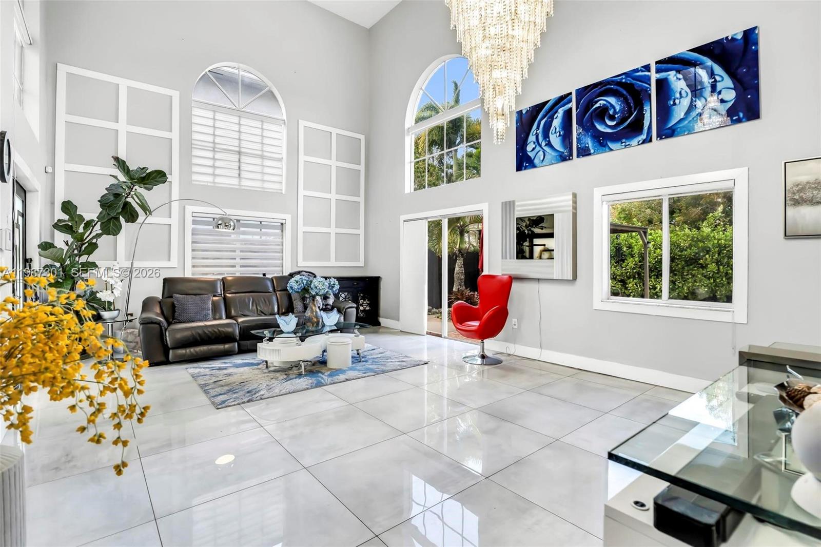 12940 Southwest 142nd Terrace Miami, FL 33186 - Photo 10 of 44 a living room with furniture and flowers