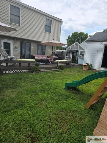 a backyard of a house with table and chairs