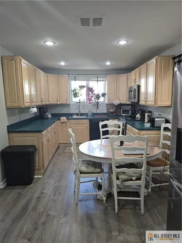 a kitchen with counter space sink appliances and cabinets